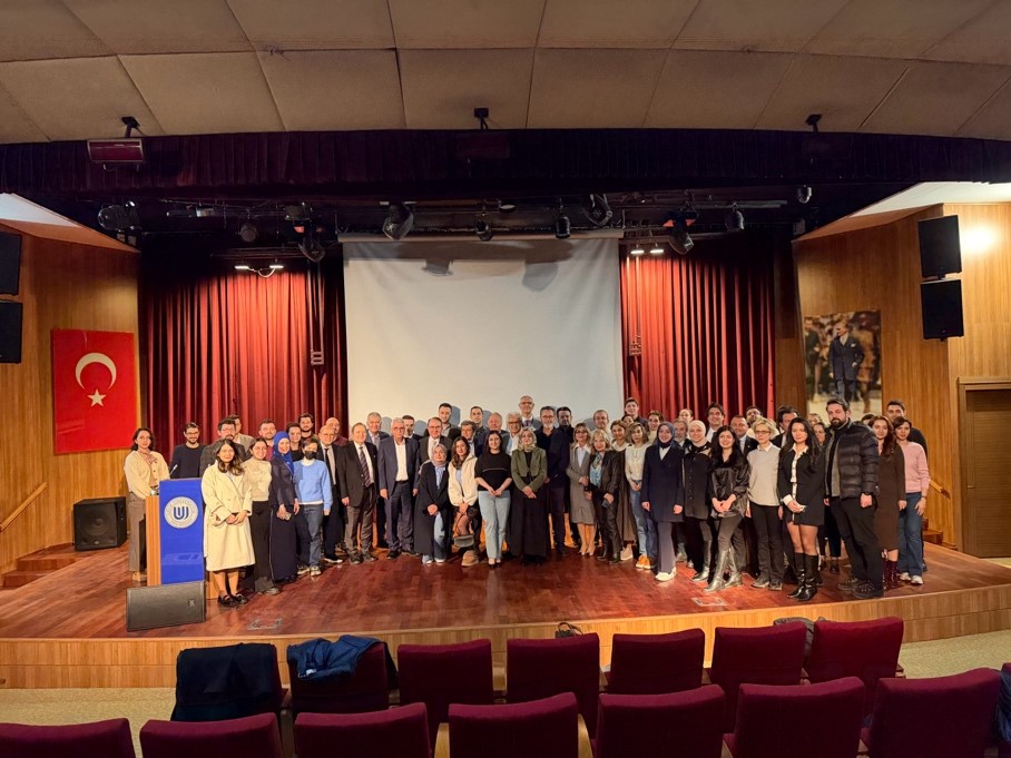 A group of people standing on a stageAI-generated content may be incorrect.